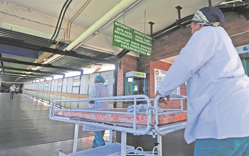 A file image of nurses pushing a bed past the entrance to the maternity ward at Northdale Hospital.