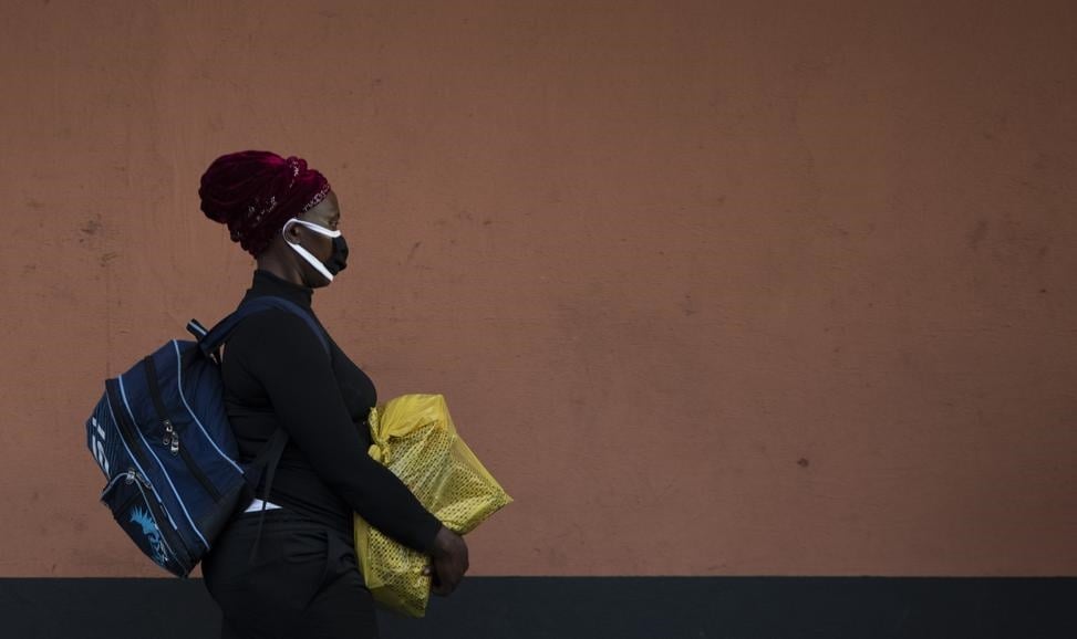 A woman, wearing a protective mask as a precaution against the spread of the new coronavirus, carries her shopping as she walks on the street in Johannesburg, SouthAfrica, Wednesday (March 25 2020) before the country of 57 million people, will go into a nationwide lockdown for 21 days from Thursday night to fight the spread of the new coronavirus. Picture: Themba Hadebe/AP