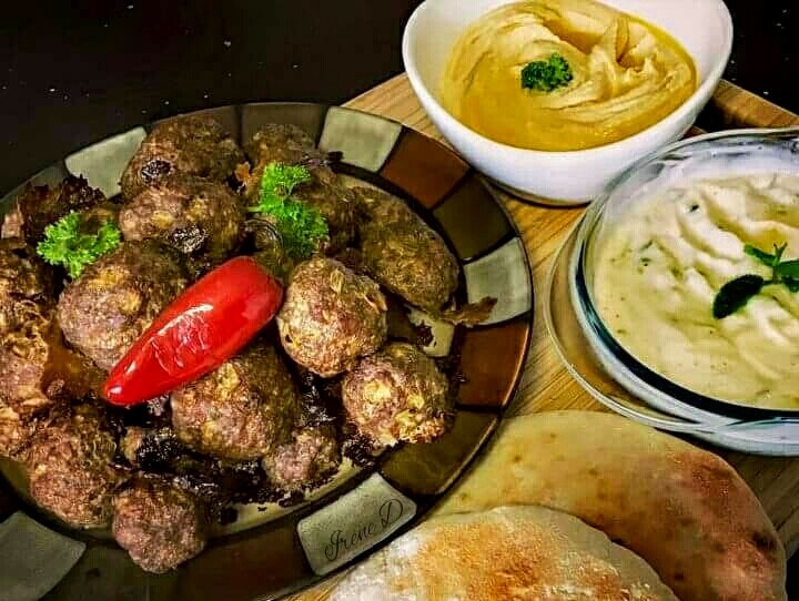 Mince kebabs with hummus and tzatziki.