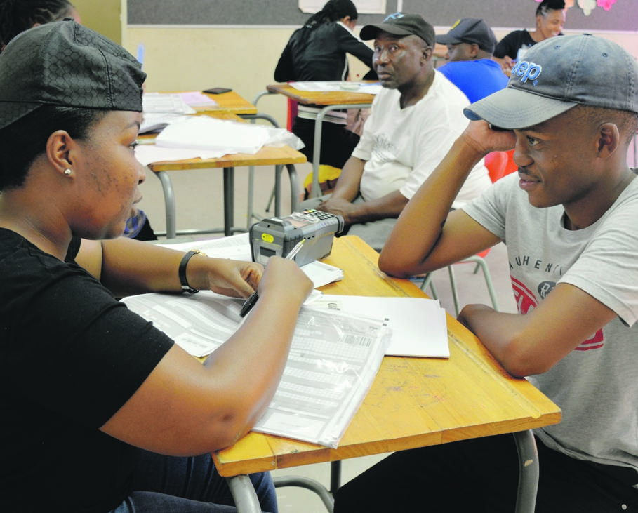 Electoral official Meabo Madlala helps Ketsile Ngwai register for the first time during last weekend’s voter registration drive Picture: Morapedi Mashashe