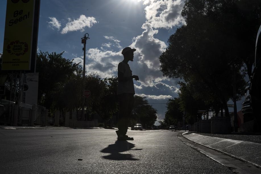 A parking guard stands in the deserted Vilakazi st