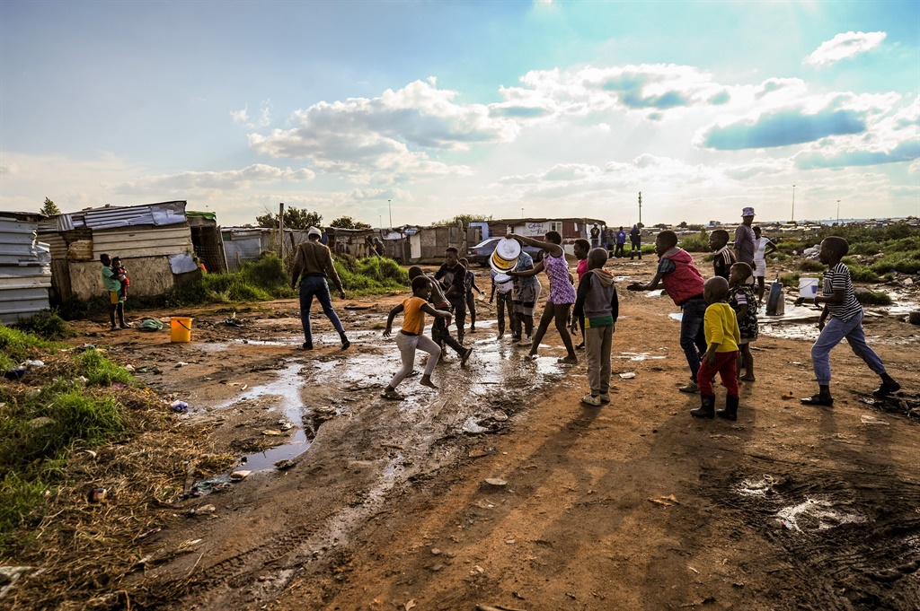 This image captures children at the Madela 2 Informal settlement on the East Rand enjoying time outside as residents say their living conditions do not make it easy for them to stay indoors. Picture: Rosetta Msimango/City Press