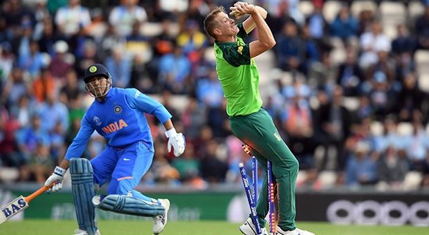 Chris Morris collides with the stumps while taking the catch of MS Dhoni (Getty Images)