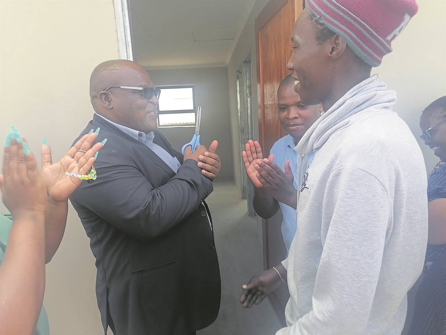KSD executive mayor Nyaniso Nelani and Ward 30 Councillor Thobani Badli officially hand over a house to elated Mpumelelo Sontanga.         