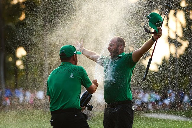 Dean Burmester of Stinger GC receives a champagne shower from team-mate Louis Oosthuizen after winning the LIV Golf Invitational - Miami at Trump National Doral Miami on 7 April 2024. (Megan Briggs/Getty Images)