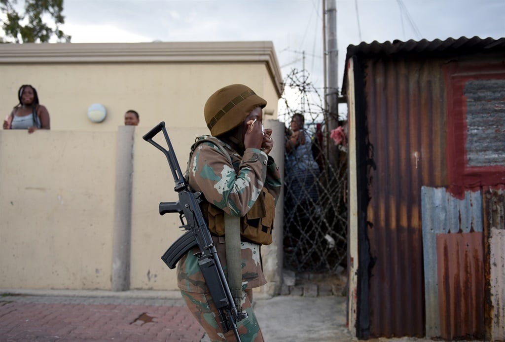 March 27.2020. People look on as the Army, SAPS an