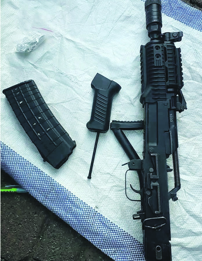 Cash and a rifle were seized by cops. 