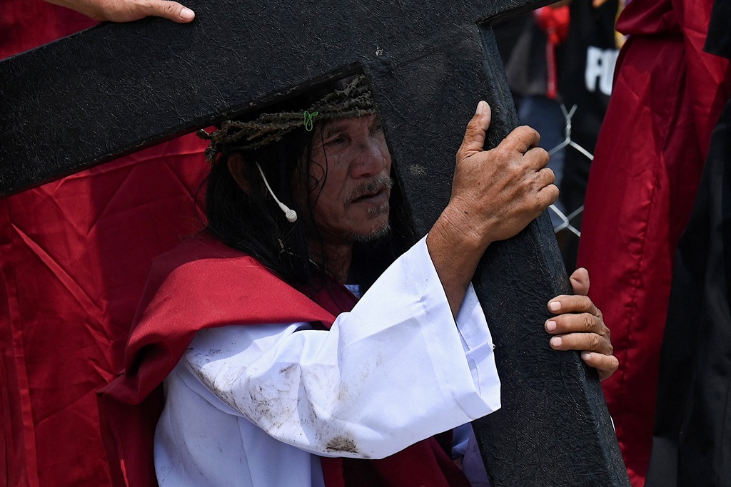 Philippine Christian devotee Ruben Enaje performs 