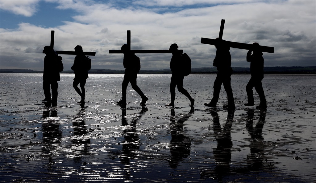 Pilgrims celebrate Easter as they walk over the ti