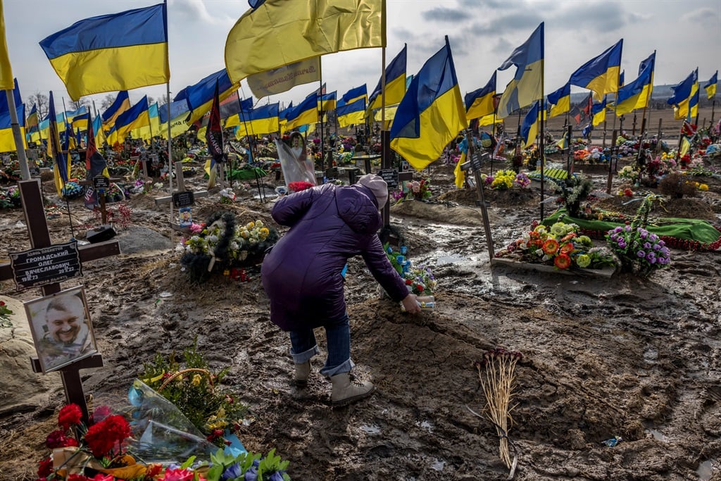 A woman places food on the grave of her son in Kharkiv, Ukraine, earlier this month. Photo: Getty Images