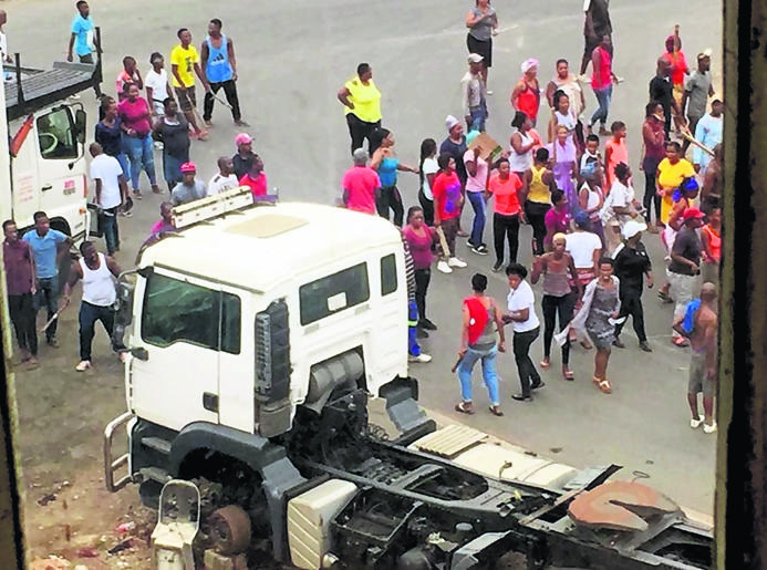 Angry residents protest after a man was allegedly mauled by a pack of dogs.