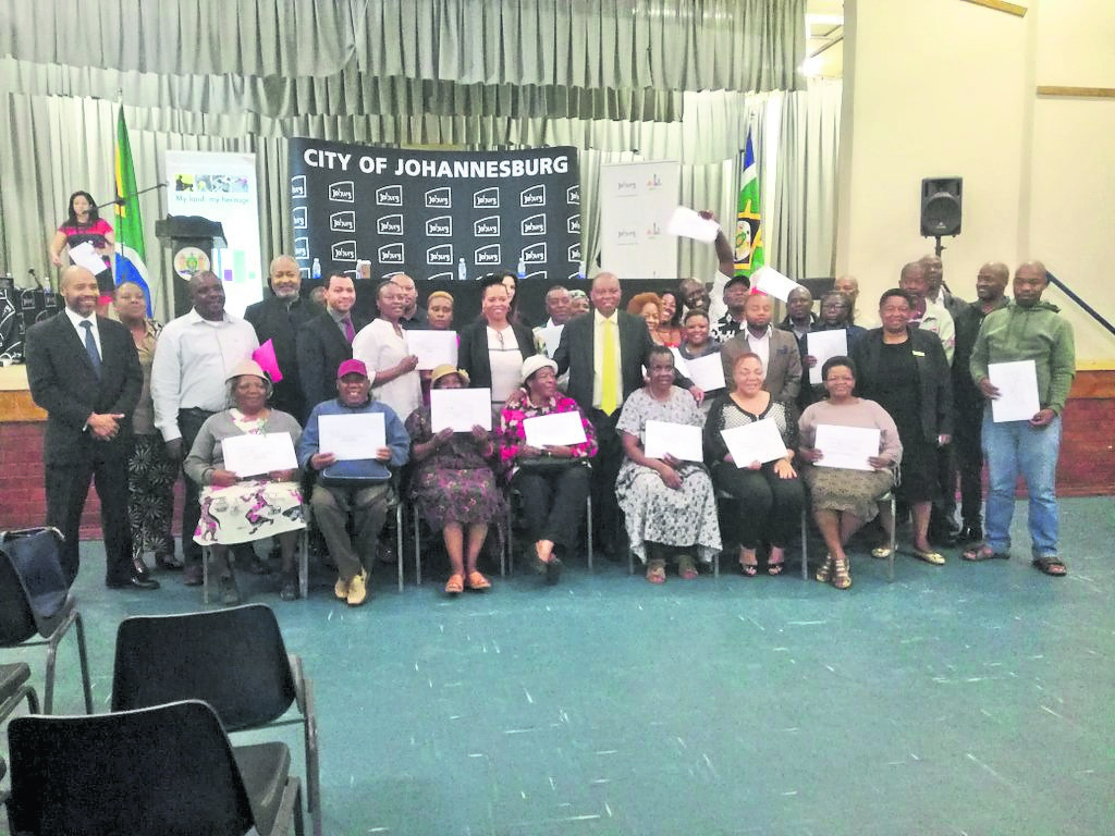 Mayor of Joburg Herman Mashaba and the 36 title deed beneficiaries at Diepkloof Multipurpose Hall in Soweto. Photo by Photo from Twitter