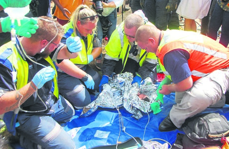 WILL TO LIVE: Rescue workers brought the newborn baby in Newlands East to safety.         Photos by        Phumlani        Thabethe
