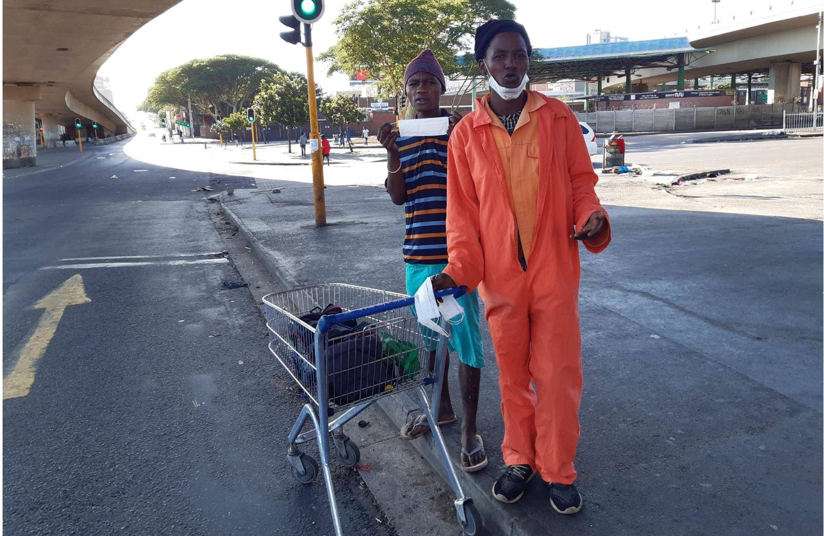 Ali and Bongani were hustling at Durban's Warwick Avenue taxi rank on Saturday, looking to make some money selling what looked like discarded face masks. Picture: Des Erasmus