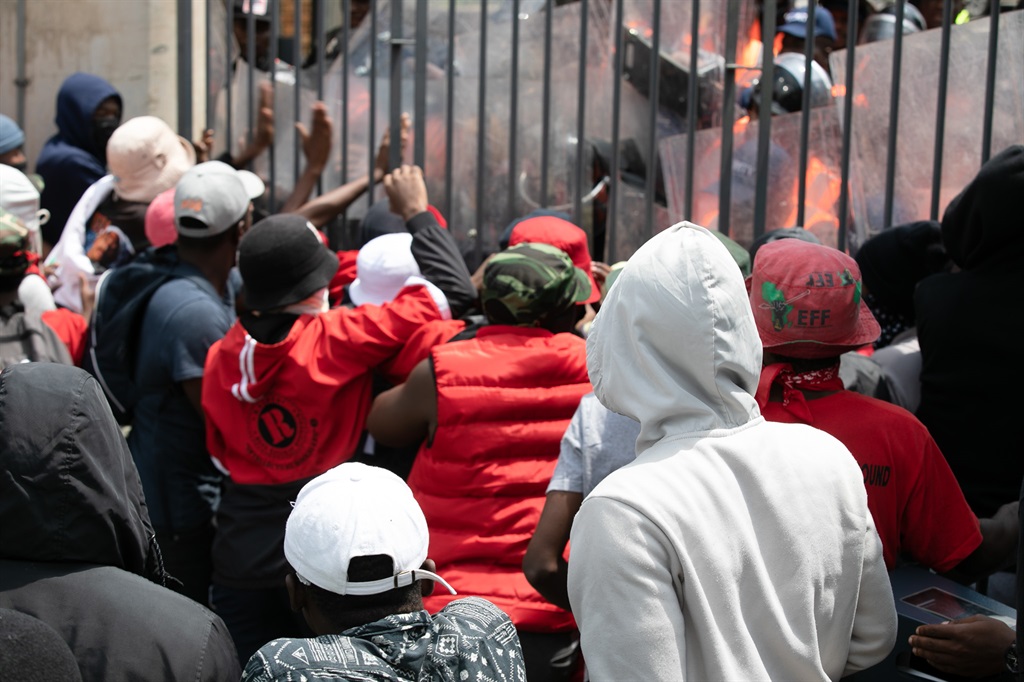 Students fight to open the gate during a protest action at Witwatersrand University earlier this month. (Photo by Gallo Images/Fani Mahuntsi)