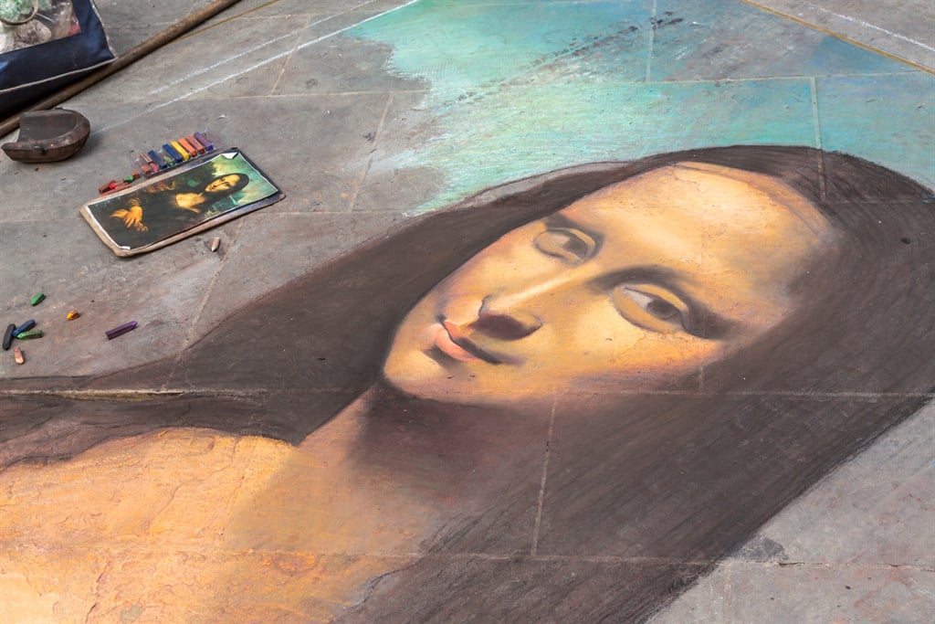 Drawing of the Mona Lisa in the streets of Florence directly on the pavement. 