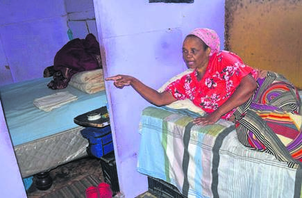 Sylvia Kendle points at the room where her husband Michael sleeps – alone.                                   Photo by Lulekwa Mbadamane