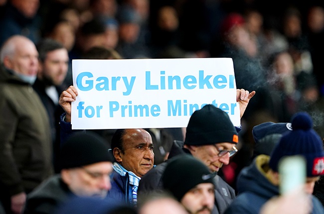 A Manchester City fan holds up a sign in support o