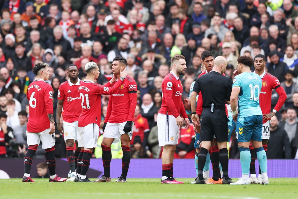 Casemiro of Manchester United is consoled by teammate Antony as he looks dejected after being shown a red card by match referee Anthony Taylor (Photo by Catherine Ivill/Getty Images)
