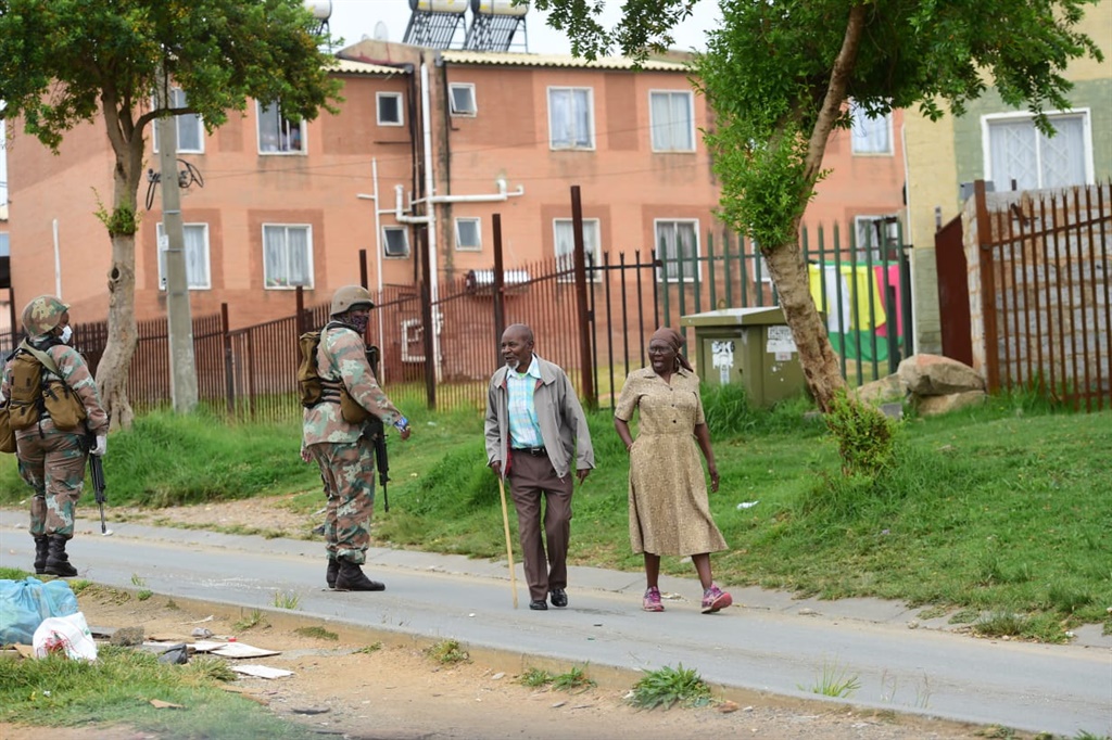 Caption: pensioners seen greeting soldiers on their way to the pay office. Photo by Trevor Kunene