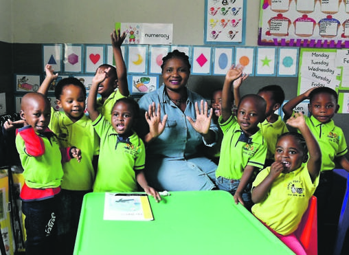 Principal Maria Tabana and pupils at Happy Feet Day Care, which is part of the Grow school group.