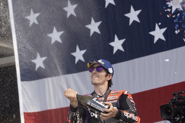Spain’s Maverick Vinales of Aprilia Racing celebrates his victory on the podium after the MotoGP Of The Americas in Austin, Texas on 14 April 2024. (Mirco Lazzari/Getty Images)