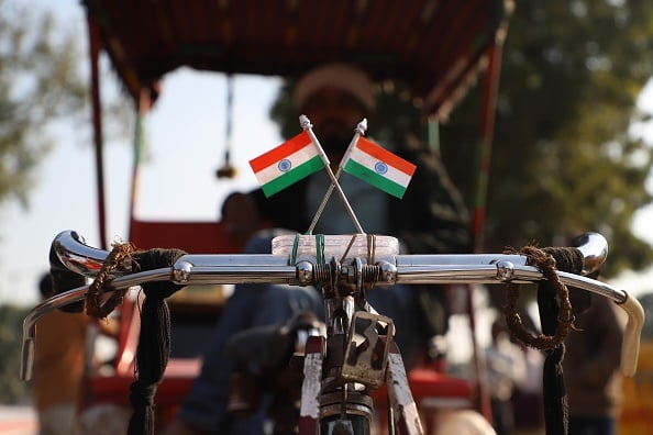 A rickshaw puller has installed the Indian flag on