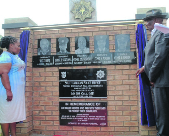 From left: Eastern Cape Transport MEC Weziwe Tikana and Police Minister Bheki Cele unveil a wall of remembrance for the five cops who were killed while on duty last year.   Photo by Ziyanda Zweni