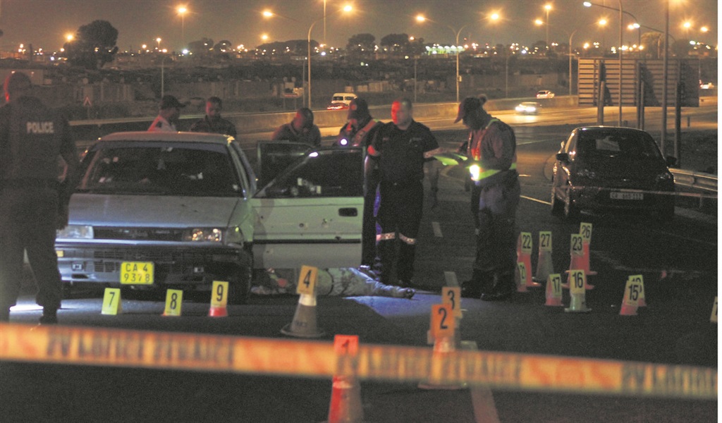 Police look for clues at the scene of a shoot out on Wednesday night. Photo by Lindile Mbontsi