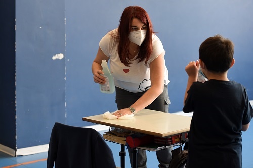 BORGOSESIA, ITALY - MAY 12: A teacher cleans a s