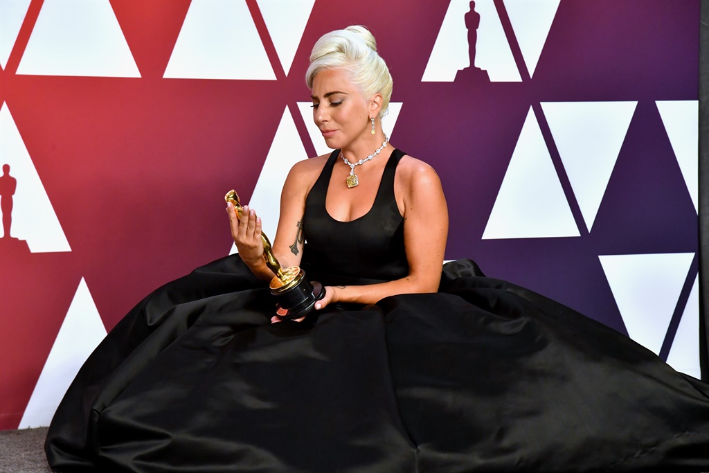 Lady Gaga poses with the best original song award for Shallow at the Oscars 2019