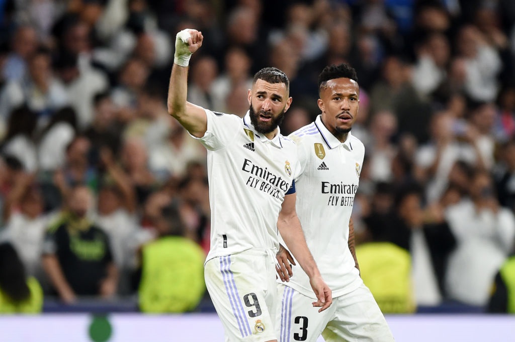 MADRID, SPAIN - MARCH 15: Karim Benzema of Real Madrid celebrates after scoring the teams first goal with teammate Eder Militao during the UEFA Champions League round of 16 leg two match between Real Madrid and Liverpool FC at Estadio Santiago Bernabeu on March 15, 2023 in Madrid, Spain. (Photo by Denis Doyle/Getty Images)