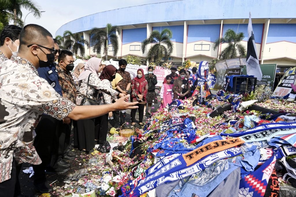 People offer flowers at the monument for Arema FC in Malang in Indonesia's East Java Province.