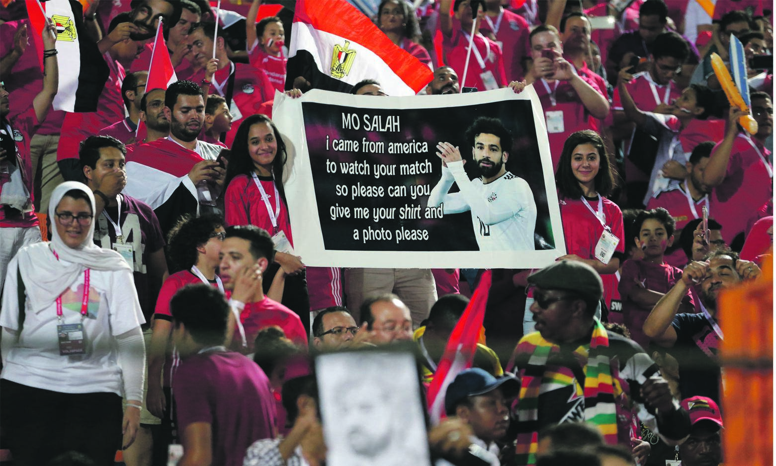 CONQUEROR Egyptian fans hold a poster of their superstar striker Mohamed Salah before the Group A soccer match against the Democratic Republic of Congo this week. Picture: Ariel Schalit / AP Photo