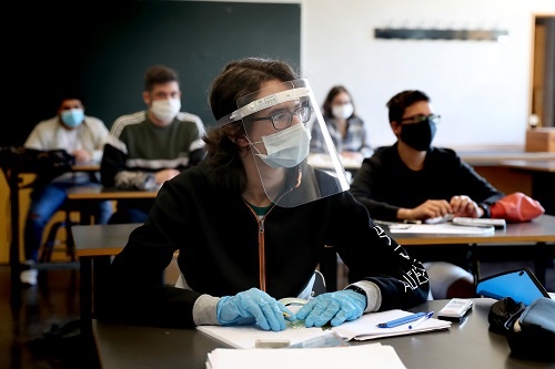 Students wearing face masks attend a class on the 