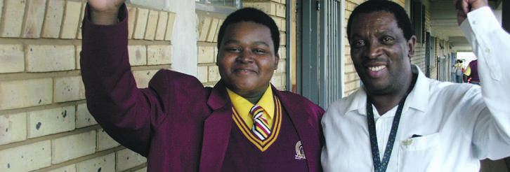 (Left) Phila Dhlamini and English teacher Pule Hlahane, celebrate at Emshukantambo Secondary in Soweto.   Photo by Malereko Tae