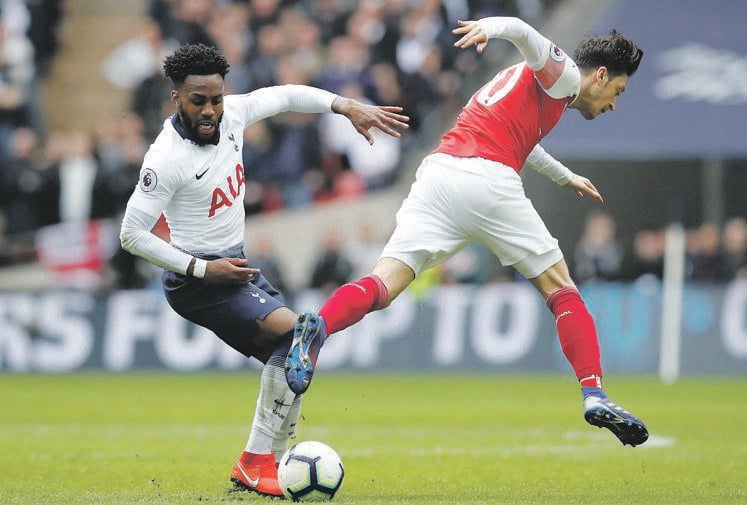 Tottenham’s Danny Rose tangles with Arsenal’s Mesut &#214;zil in yesterday’s Premier League derby at Wembley Stadium Picture: David Klein / REUTERS