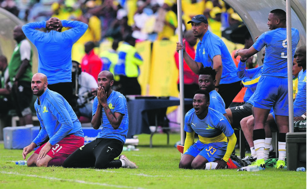 When Emiliano Tade of Mamelodi Sundowns misses a scoring opportunity, those on the bench fall to their knees in disappointment during their Absa Premiership match against Bloemfontein Celtic in Pretoria yesterday Picture: Gallo Images