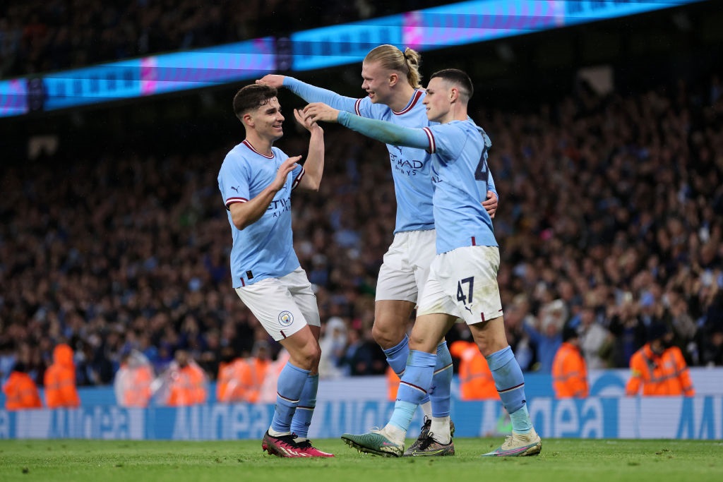 MANCHESTER, ENGLAND - MARCH 18: Erling Haaland of Manchester City celebrates with teammate Phil Foden and Julian Alvarez after scoring the teams first goal during the Emirates FA Cup Quarter Final match between Manchester City and Burnley at Etihad Stadium on March 18, 2023 in Manchester, England. (Photo by Clive Brunskill/Getty Images)