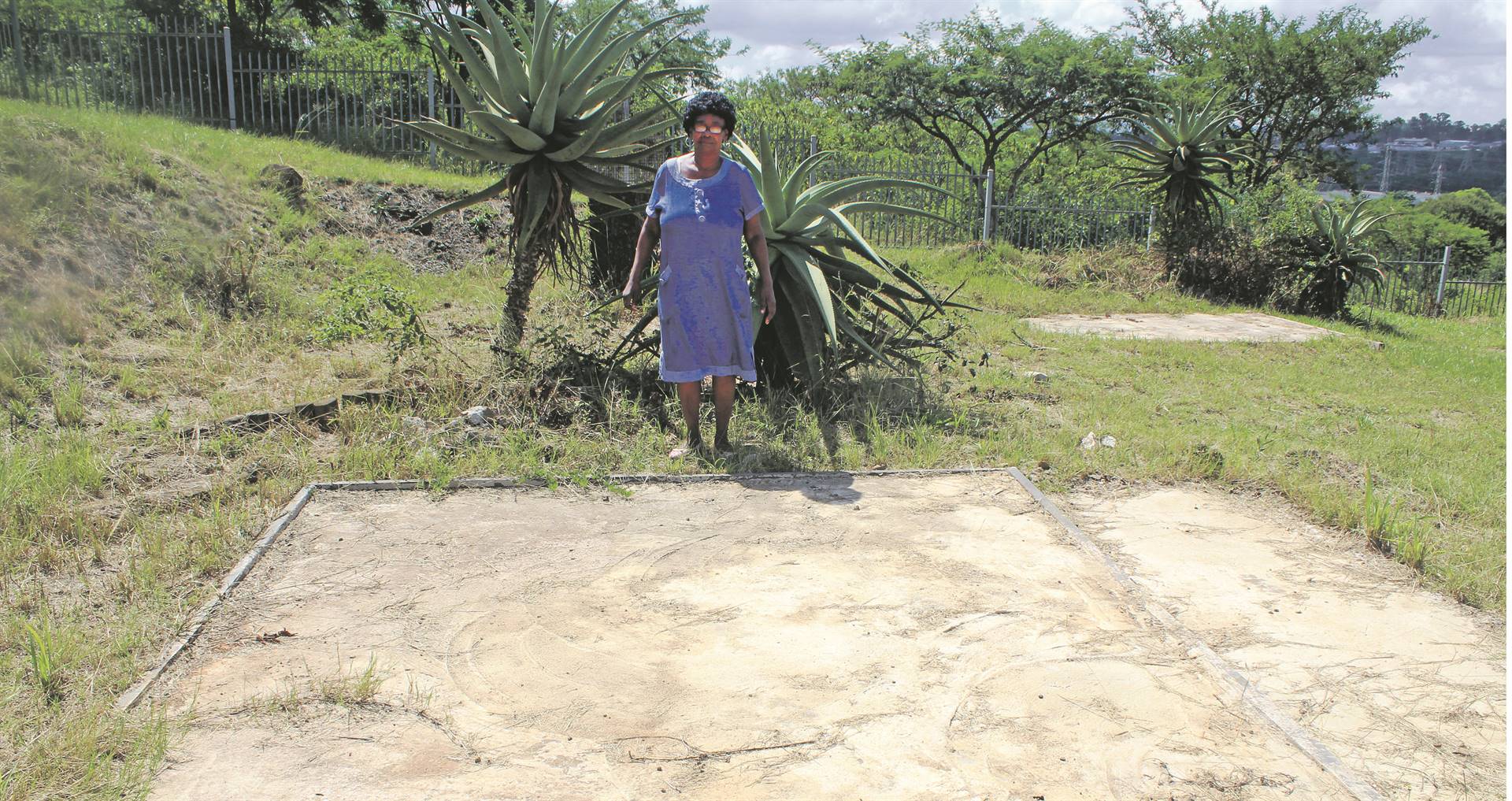 Thuthukile Mabhida, daughter of struggle stalwart Moses Mabhida, stands next to her grandfather’s grave, minus its tombstone, at Heroes Acre in Imbali Township, Pietermaritzburg