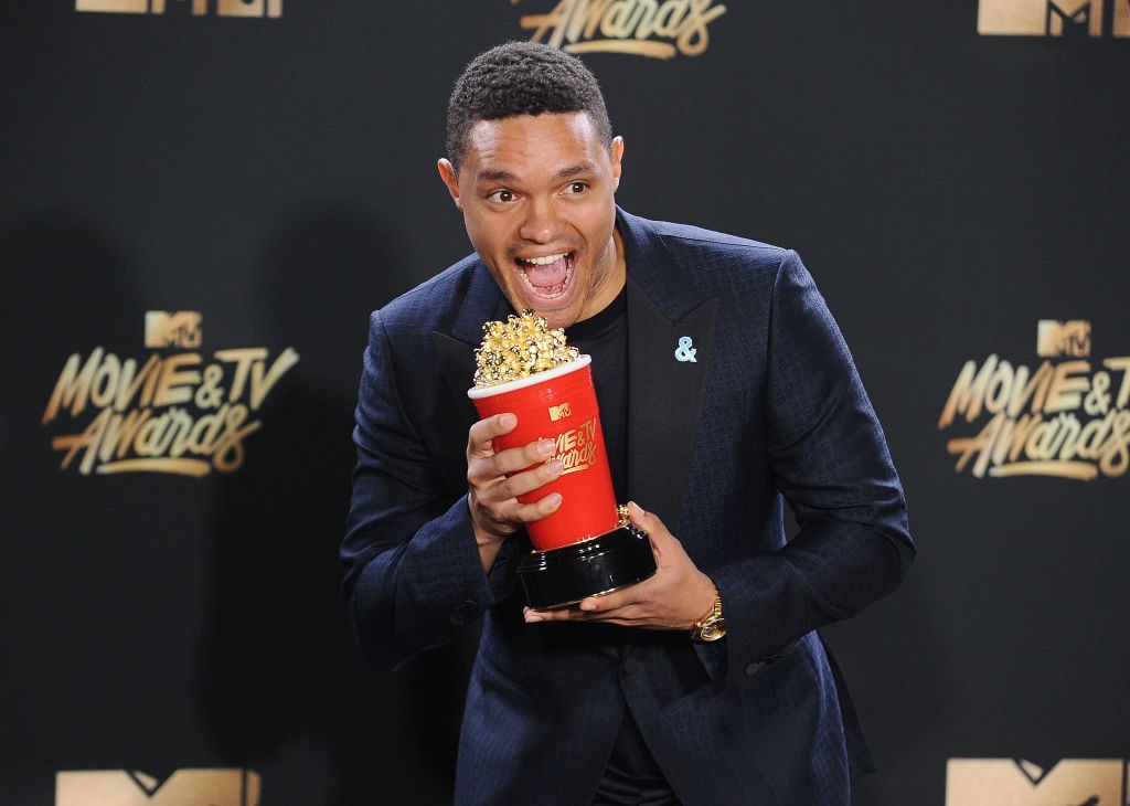 Trevor Noah poses with his award in the press room