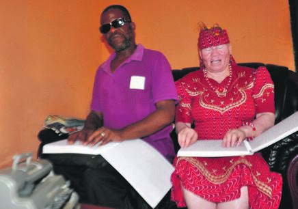 Mary and her husband Livingstone Ganyile give a demonstration of how they read Braille at home.      Photo by  Thabo Monama