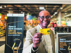 TymeBank CEO Sandile Shabalala demonstrates how digital banking services work at a retailer.