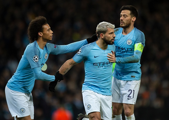 Sergio Aguero of Manchester City is congratulated by team mates Leroy Sane and David Silva after scoring a penalty during the UEFA Champions League 