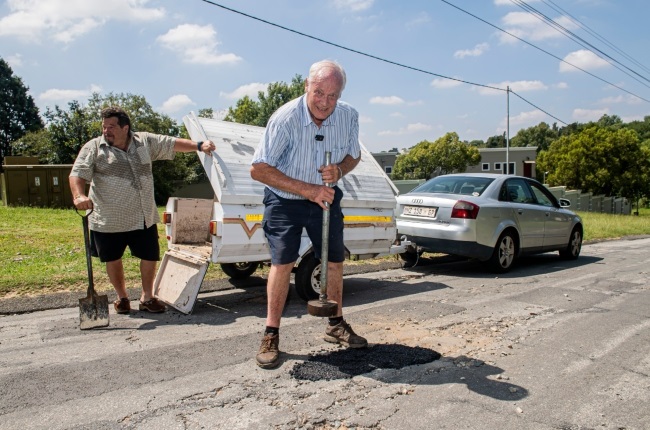 Retired engineer Rainer Dixel fixes potholes in his Joburg neighbourhood. His friend Andy Leitner (left) accompanied him on the day YOU visited. (PHOTO: Rapport Deon Raath)