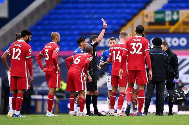 Referee Michael Oliver shows a red card to Richarlison of Everton during the Premier League match against Liverpool at Goodison Park on 17 October 2020. 
