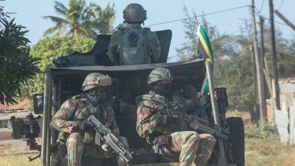 A military convoy of the SANDF rides along a dirt road in the Maringanha district in Pemba, Mozambique. A terrorist insurgency in the country has left more than 3 000 people dead and halted Africa's biggest private investment yet. (Alfredo Zuniga/AFP)