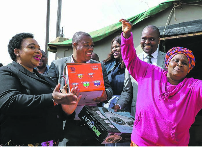 Co-operative Governance MEC Nomusa Dube-Ncube (left) hands over electrical appliances to an ululating Nomahomba Mkhize.