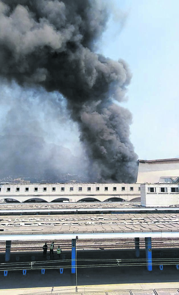 Two trains burned down at Cape Town Station on Sunday afternoon.  Photo by Misheck Makora