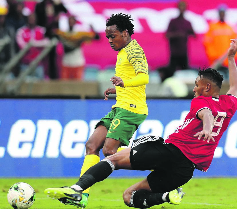 Bafana Bafana nimble midfielder, Percy Tau (left), will again engage against his Libyan opponent Sand Masaud Masaud in Sfax, Tunisia on Sunday.   Photos by Themba Makofane and      Backpagepix